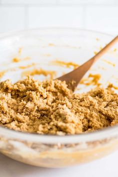 a bowl filled with food and a wooden spoon