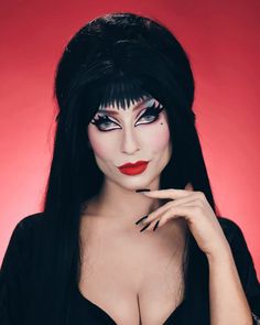 a woman with long black hair and makeup