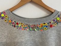 embroidery ideas Hand Embroidery Top Designs, Embroidery On A Sweatshirt, Jumper Embroidery Ideas, Embroidered Jumper Diy, Embroidery On Jumper, Embroidery Designs On Sweatshirts, Embroidery Collar Design, Embroidery Sleeve Designs, Embroidery Sweatshirt Diy