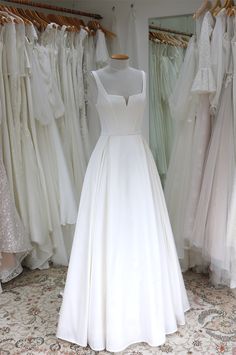 a white wedding dress on display in a bridal shop