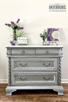 an old dresser with some flowers on top