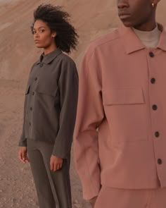 two people standing next to each other in the desert