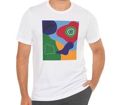 This tee features blue, red, yellow, and green abstract shapes with design elements that have been put together in an abstract collage. Stand out from the others with this bright and colorful t-shirt.  This makes a great gift for the art teacher, for the contemporary art lover, or for the art enthusiast.   This classic unisex jersey short sleeve tee fits like a well-loved favorite. Soft cotton and quality print make users fall in love with it over and over again. These t-shirts have-ribbed knit collars to bolster shaping. The shoulders are tapered for a better fit over time. Dual side seams hold the garment's shape for longer.  .: Made with 100% Airlume combed and ring-spun cotton, a lightweight fabric (4.2 oz/yd² (142 g/m that is easy to layer, breathable. Perfect for active and leisure w Multicolor Abstract Print Casual T-shirt, Artsy Short Sleeve T-shirt With Artwork, Casual Multicolor Abstract Print T-shirt, Artsy Multicolor Screen Print T-shirt, Artistic Cotton T-shirt With Abstract Print, Multicolor Crew Neck T-shirt With Abstract Print, Multicolor Abstract Print Crew Neck T-shirt, Multicolor Graphic T-shirt With Short Sleeves, Multicolor Graphic Design Short Sleeve T-shirt