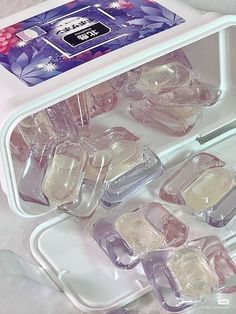 an open refrigerator filled with lots of different types of ice cubes and water bottles