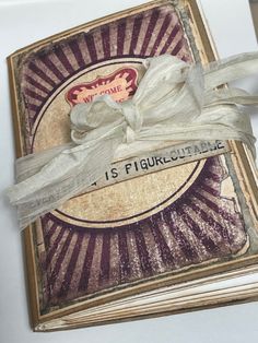 an old book with ribbon tied around the edge and some writing on it that says is fiquiculaable