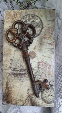 an old rusty key sitting on top of a piece of paper