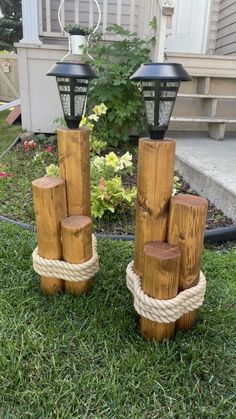 wooden logs are stacked on top of each other in the grass near a light pole