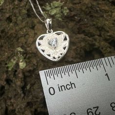 Double the love with two hearts on one pendant! A sparkling clear heart shaped cubic zirconia is framed with a cutout Hawaiian Scroll heart shaped design. Perfect for the special wahine in your life. This .925 sterling silver pendant includes a matching adjustable 18 inch chain. .925 Sterling Silver Cubic Zirconia Heart Shaped Stone Approximately 3/4" x 5/8" Includes 18" Adjustable Chain Cubic Zirconia Filigree Jewelry Gift, Silver Heart Necklace With Birthstone - Cubic Zirconia, Sterling Silver Heart Necklace With Brilliant Cut Pendant, Sterling Silver Heart Pendant Necklace With Brilliant Cut, Heart-shaped Cubic Zirconia Promise Jewelry, Sterling Silver Jewelry With Heart Charm In Diamond White, Sterling Silver Heart Necklace With Brilliant Cut, Sterling Silver Brilliant Cut Heart Pendant Necklace, Sterling Silver Jewelry With Diamond White Heart Charm