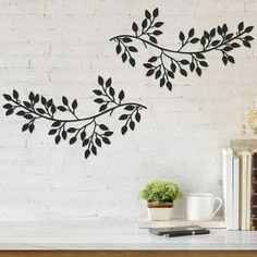 the wall decals are decorated with black leaves