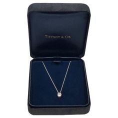 Circa 2010 Tiffany & Company Diamond Solitaire Pendant Necklace, suspended from a 16 inch Platinum chain, a Platinum 4 prong mount holds a .61 Carat Round Brilliant cut Diamond that is G in color and VS in clarity, comes in the original Tiffany presentation box. Current retail price new is approximately $7,900. Pendant Jewelry Tiffany & Co., Tiffany Diamond Necklace, Diamond Necklace Tiffany, Tiffany And Co Jewelry, Diamond Solitaire Pendant, Platinum Chain, Solitaire Pendant Necklace, Tiffany And Co, Solitaire Pendant