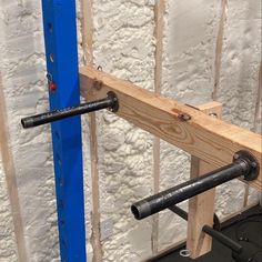 the bars are attached to the wall and ready to be used as a barbell holder