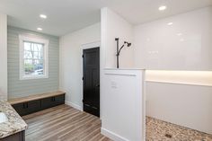 the kitchen is clean and ready to be used as a mudroom or laundry room