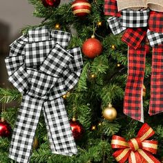 the christmas tree is decorated with red, black and white plaid bowes on it