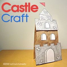 a castle made out of paper sitting on top of a table next to a sign that says castle craft