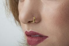 Nose Ring- Solid 14k gold nostril jewelry Your nose is at the forefront of your façade. Nose jewelry is the first body adornment people observe when looking at you. We make your entire look stand out just by decorating your nose with our unique solid gold piercing jewelry, handmade to fit your specific body features as accurately & stunningly as can be. The nose jewelry we make is of the highest quality, both materials & craftsmanship wise. Treat yourself with it. It'll be your best frie Minimalist 14k Gold Nose Ring For Wedding, Hypoallergenic Small Hoop Nose Ring For Wedding, Hoop Nose Rings For Anniversary, Minimalist Yellow Gold Nose Rings For Anniversary, Minimalist Round Septum Ring For Wedding, Minimalist Gold Septum Ring For Wedding, Minimalist 14k Gold Nose Ring As Gift, Minimalist Yellow Gold Septum Ring For Wedding, Minimalist Gold Wedding Septum Ring