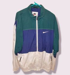 THIS JACKET IS IN EXCELLENT CONDITION, EXTREMELY CLEAN, & WELL KEPT VINTAGE, OFFICIALLY LICENSED, GENUINE, NIKE FULL ZIPPER WINDBREAKER JACKET MADE OF THE FOLLOWING:      BODY 100% NYLON     LINER 35% COTTON 65% POLYESTER SIZE MENS LT APPROX. MEASURMENTS: LENGTH (TOP TO BOTTOM) 29.5" & WIDTH (PIT TO PIT) 24" EXPRESS & INTERNATIONAL SHIPPING AVAILABLE ITEM SHIPS WITHIN 1 BUSINESS DAY PLEASE FEEL FREE TO ASK ANY QUESTIONS Green Nike Windbreaker For Sports, 90s Style Green Track Jacket For Sports, Nike Green Sportswear Windbreaker, 90s Green Sports Windbreaker, 90s Green Sports Outerwear, Green Nike Track Jacket For Streetwear, Nike Green Casual Windbreaker, Nike Green Casual Track Jacket, Nike Casual Green Track Jacket