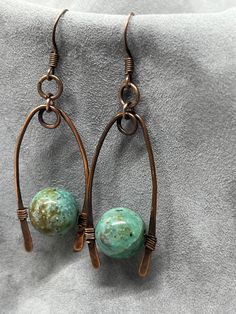 handmade earrings featuring jasper in a teal color with copper settings, unique and beautiful Artisan Copper Wire Drop Earrings, Artisan Handmade Earrings With Copper Wire, Artisan Handmade Earrings In Copper Wire, Artisan Wire Wrapped Copper Earrings, Artisan Handmade Copper Wire Earrings, Artisan Copper Wire Wrapped Earrings, Bohemian Teardrop Copper Wire Jewelry, Adjustable Jasper Jewelry In Turquoise, Handmade Bohemian Ocean Jasper Jewelry