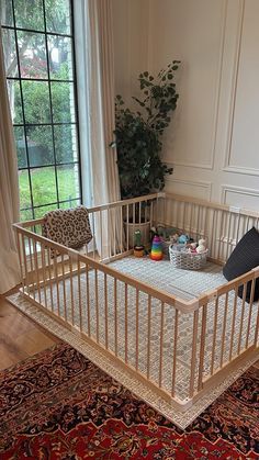 a baby crib in the middle of a living room