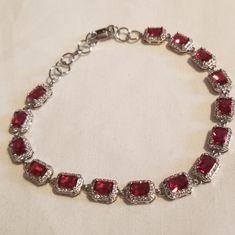 *Vintage Ruby,White Topaz Set In Sterling Silver (925) Bracelet Stamped 925 Measures:7.5" With 1" Extender Fits Most Size Wrists Adjustable Beautiful Rectangular Ruby With White Topaz Halo Around Each One Tennis Bracelet Style *Vintage In Style Or Age Not Condition;Nwot Condition Any Questions Please Feel Free To Ask!Or Make Me A Reasonable Offer! Red Ruby Jewelry, Classic Sterling Silver Party Bracelet, Formal Silver Ruby Bracelets, Red Sterling Silver Anniversary Bracelet, Red Sterling Silver Vintage Bracelets, Formal Red Sterling Silver Bracelet, Red Sterling Silver Bracelet For Formal Occasions, Red Sterling Silver Bracelet For Anniversary, Elegant Red Sterling Silver Bracelet