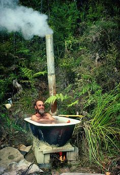 a man sitting in an old fashioned bath tub