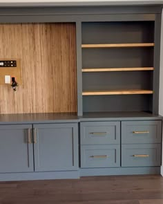 an empty room with some shelves and drawers