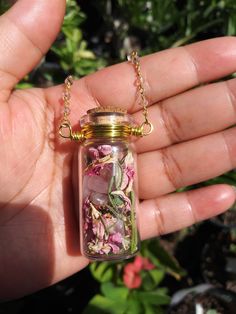 This Love & Protection Spell Bottle Pendant has been handcrafted by myself and my daughter using specially selected herbs and crystals protected beneath my altar.  This bottle has been lovingly imbued with the powerful solar energy of the sun, the loving and beautification properties within baby pink rose petals, rosemary for consecration and divine protection and rose quartz, a stone that harnesses the power of universal love and healing.  My items come packaged in dried herbs and flowers so please message if you have any allergies to anything prior.  Please do not wear this charm in water, as it may damage it.  Sold as curio and not a cure. Thank you for viewing. Potion Vial, Pink Rose Petals, Witch Supplies, Vial Necklace, Protection Spell, Bottle Stand, Herbal Magic, Bottle Jewelry, Witchy Jewelry