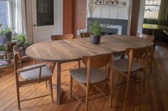 a dining room table with chairs and a potted plant on the top of it