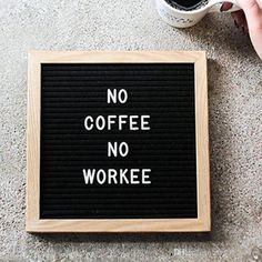 a sign that says no coffee no workee on the ground next to a cup of coffee