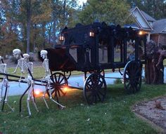 skeletons are riding in a horse drawn carriage with lights on it's wheels and skeleton statues