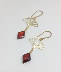 "Lovely gold Vermeil earrings with red Cubic Zirconia (CZ). These earrings evoke the romantic style of a bygone era known as the 1920's where Art Deco design was all the rage! The Vermeil fan shape is both feminine and stylish with a clear red CZ gemstone that is faceted and cut into a diamond shape that enhances its pure red color! Simply stunning, you will not go unnoticed while wearing these beauties. Perfect for your next holiday event or any other occasion. These earrings are light weight a Antique Brass Jewelry For Party, Elegant Christmas Anniversary Earrings, Classic Gold Crystal Earrings With Ear Wire, Party Brass Filigree Earrings, Classic Brass Jewelry For Party, Antique Yellow Gold Jewelry For Parties, Victorian Dangle Earrings For Party, Red Chandelier Earrings As Gift, Elegant Christmas Celebration Earrings