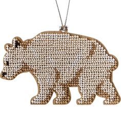 a brown bear ornament hanging from a chain on a white background with beads