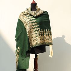 Deep green high-quality embroidered Kashmiri pashmina wool shawl. The perfect deep green color layered with detailed beige color border embroidery. This shawl is ideal to be paired with neutral or colored outfits this winter season. This piece is fully embroidered by machine and in a medium length, ideal for pairing with basic single-tone outfits. Perfect for formal occasions to add a pop of color to your outfits. The perfect medium-length shawl to pair with both eastern and western outfits. ideal for both indoor and outdoor use for a variety of occasions. Each piece is uniquely crafted and available in limited quantity and sizing. Ideal gift Weddings, Anniversaries, Birthdays and other occasions & celebrations. A thoughtful Valentines Day gift for Her. Ideal gift Weddings, Anniversaries, Traditional Embroidered Green Shawl, Green Shawl With Resham Embroidery In Traditional Drape, Green Embroidered Dupatta Shawl, Elegant Green Embroidered Shawl, Green Embroidered Shawl Dupatta, Embroidered Green Shawl Dupatta, Traditional Dark Green Dupatta With Resham Embroidery, Bohemian Embroidered Green Dupatta, Green Pashmina Shawl For Wedding