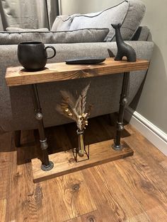 a living room with a couch, coffee table and vase