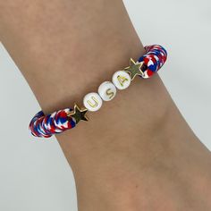 a bracelet with the word usa written on it and two star charms attached to it