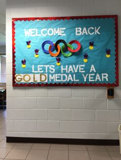 a welcome back sign hangs on the wall