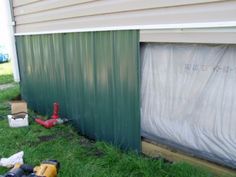 some tools are laying on the grass next to a shed