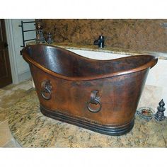 an old fashioned copper bathtub in a bathroom