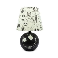 a black and white table lamp with a jack skellingy face design on it