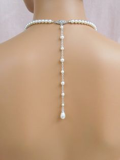 "Glamorous yet simple and elegant! I've created the Alyssa Jewelry pieces using Swarovski pearls and crystal component for a classic and elegant look. The beautifully detailed filigree clasp is custom designed by me. Backdrop measures 8\". If you want the backdrop longer or shorter, please message me! Alyssa Earrings measure 1.5\" (36mm) Front necklace drop measures 1.5\" (36mm) Shown with white/light ivory Swarovski pearls. Also available with cream or cream rose Swarovski pearls. Please state Classic Crystal Pearl Necklace For Wedding, Elegant Single Strand Bridal Necklace For Wedding, Classic Wedding Pearl Necklace, Classic Crystal Bridal Necklace For Wedding, Single Strand Pearl Necklace For Wedding, Pearl White Crystal Bridal Necklace For Anniversary, Adjustable Crystal Backdrop Necklace For Wedding, Pearl White Crystal Bridal Necklace For Wedding, Adjustable Pearl Drop Bridal Necklace For Formal Events