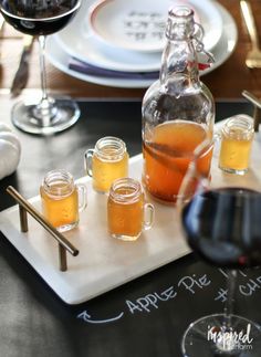 there are glasses and bottles on the table