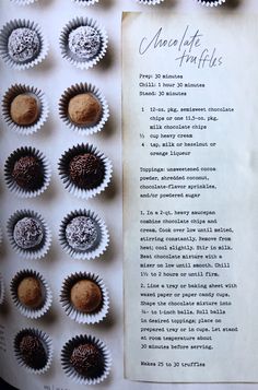 chocolate truffles are lined up on a sheet of paper next to an old recipe book