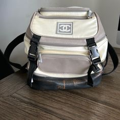 Pre Owned Chanel Nylon/Leather Sport Backpack. Authentic With Authenticity Card And Number. Good Condition. Some Staining Around The One Zipper, Very Small Amount Of Wear On The Piping Around Pockets. Leather Bottom Has Some Browning. Some Discoloration And Some Spots On Nylon. Smoke Free Home. Mini Backpack. Measures Around 9.5in Across The Base And Stands Around 9.5in Tall. Designer Beige Backpack For Travel, Luxury Beige Nylon Bag, Luxury Cream Backpack For Travel, Designer Beige Backpack For Everyday Use, Designer Nylon School Bags, Sport Backpack, Chanel Vintage, Backpack Sport, Vintage Chanel