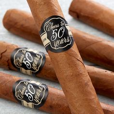 five cigars lined up in a row on top of each other with the words 50 years printed on them