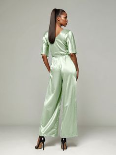 This soft satin jumpsuit features a flattering v-neck design, making it the perfect choice for mothers of the bride. Its dress pantsuit style provides comfort and elegance, while its high-quality material ensures a polished look. Stay stylish and comfortable on that special day with our jumpsuit. Silk V-neck Party Sets, Fitted V-neck Evening Sets, Elegant V-neck Workwear Sets, Chic Satin V-neck Jumpsuits And Rompers, Chic Satin Suits For Evening, Chic Satin Evening Suits, Chic Evening Suits In Satin, Elegant Satin Sets For Workwear, Satin Evening Sets