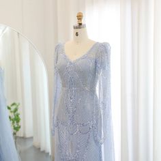 Make a statement in this luxurious Dreamy Vow Mermaid Light Blue Evening Dress with flowing cape sleeves. Elegant and flattering, this plus size gown is perfect for any wedding guest or party. You'll feel like royalty in this stunning piece. Elegant Blue Evening Dress With Cape Sleeves, Elegant Blue Gown With Cape Sleeves, Blue Gown With Cape Sleeves For Party, Blue Wedding Gown With Cape Sleeves, Dresses With Cape Sleeves, Mermaid Light, Yellow Evening Dresses, Grey Evening Dresses, Champagne Evening Dress