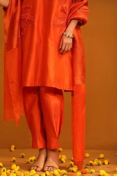 Orange straight kurta with floral applique patch work. Paired with a trouser and dupatta. - Aza Fashions Orange Traditional Wear With Dabka Work, Eid Cotton Silk Sets, Unstitched Cotton Silk Sets, Puja Kurta With Traditional Drape, Traditional Raw Silk Sets For Summer, Tissue Silk Dupatta With Self Design, Tissue Silk Dupatta With Dabka, Tissue Silk Traditional Drape Sets, Tissue Silk Dupatta For Navratri