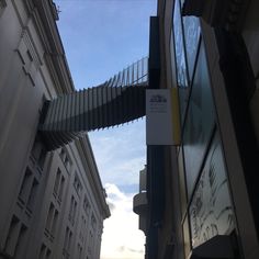 the sky is very blue and there are buildings in the street with signs on them