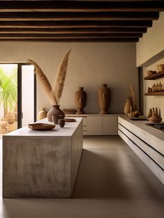 a kitchen with vases and bowls on the counter