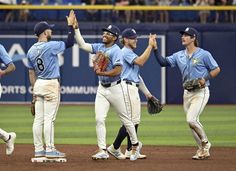 the baseball players are giving each other high fives