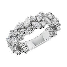 a white gold ring with pear shaped diamonds on the sides and an oval design in the middle